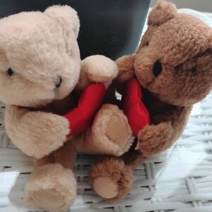 2 Russ Teddy Bears each holds a red  heart
